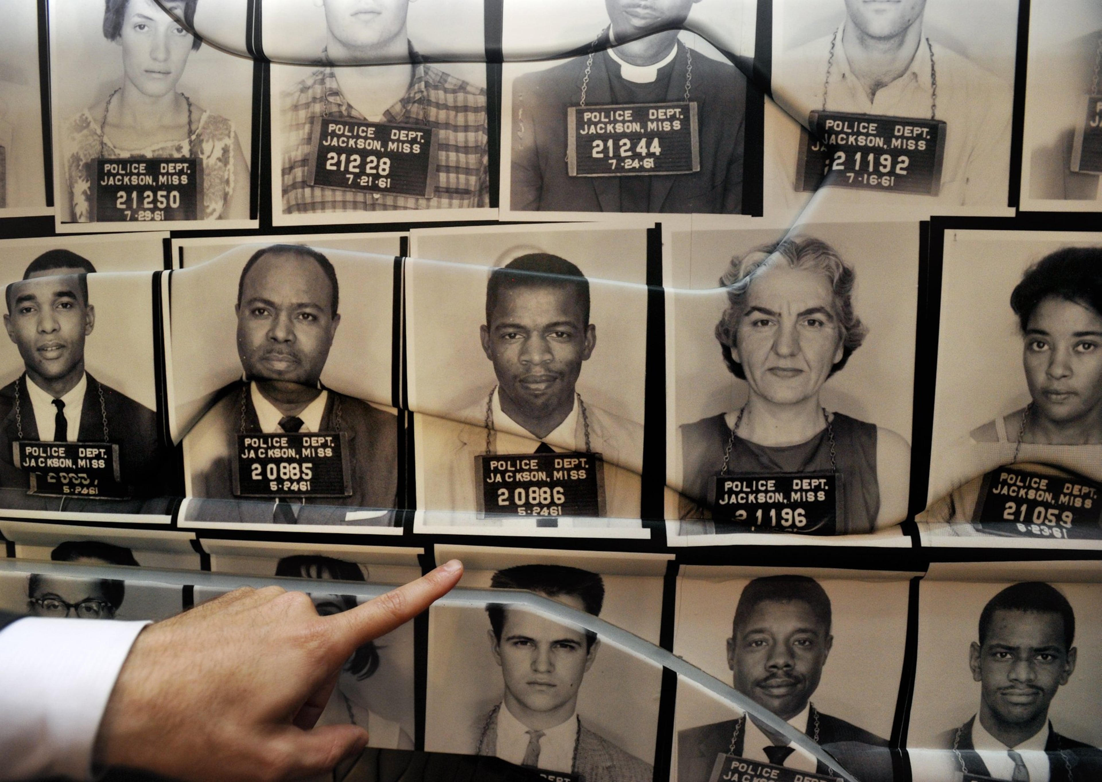 A wall of police mug shots of students arrested during a Freedom Ride (including future Congressman John Lewis, D-Ga.) show that most the men were wearing suits and ties. The Freedom Rider exhibit is part of the civil rights gallery at the National Center for Civil and Human Rights in Atlanta. (David Tulis for the AJC)