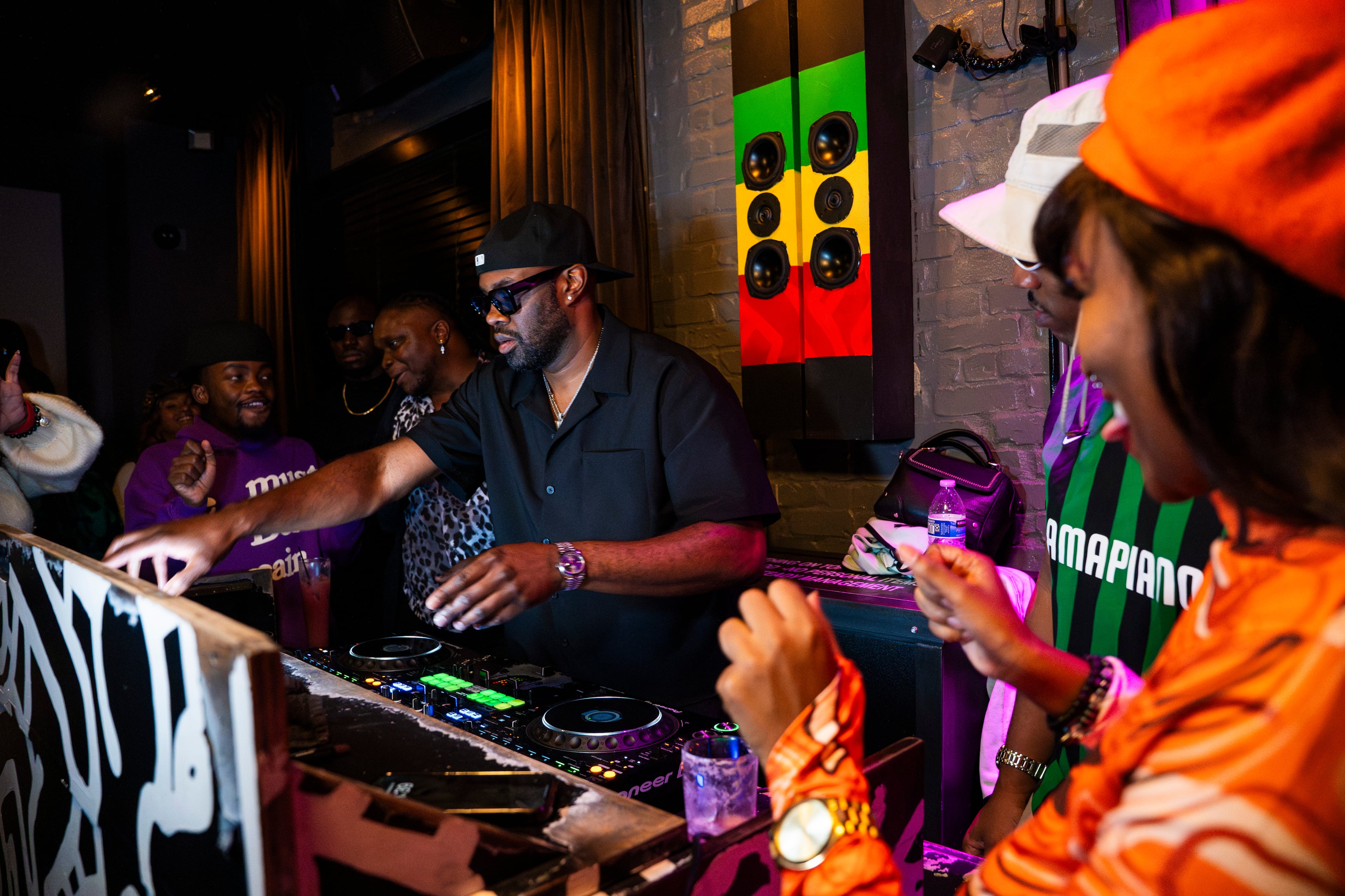 Party-goers dance and enjoy the local scene at Bamba Tuesdays, a premier amapiano dance party hosted by DJ Kash in Atlanta, on Oct. 15, 2024. (Olivia Bowdoin for the AJC)