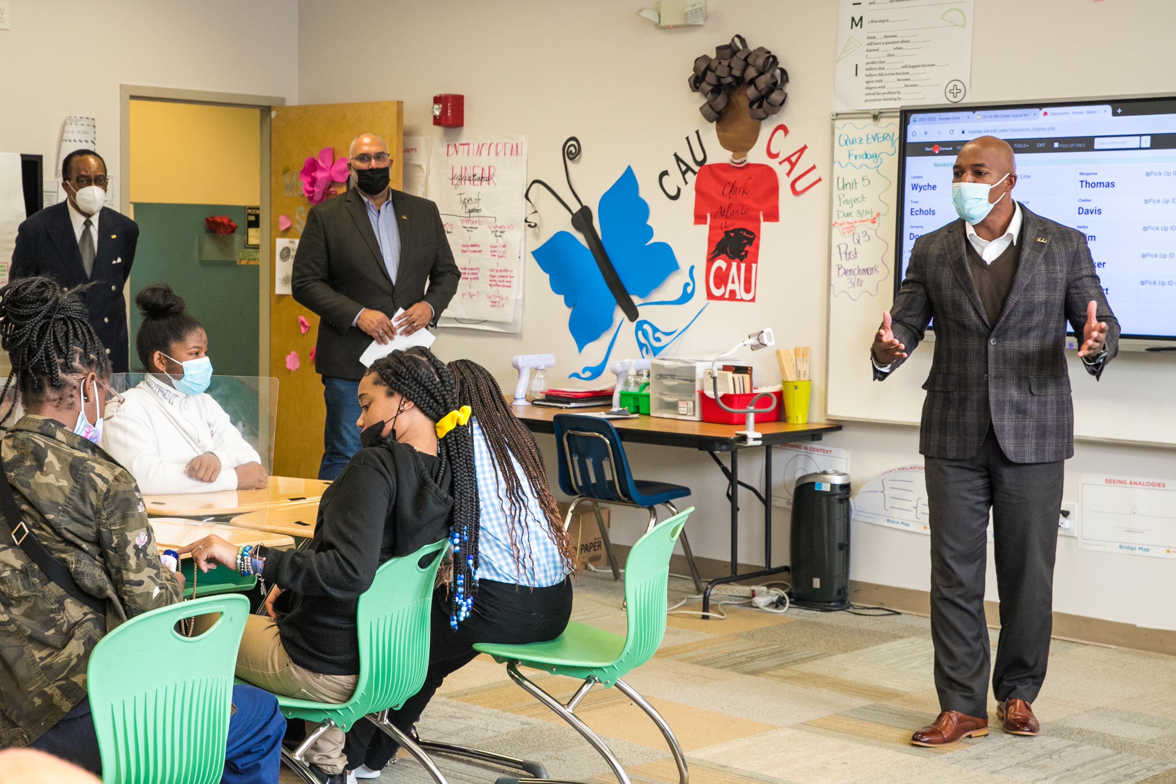 Members of 100 Black Men, including Joshua Byrd, leading the program, offer mentoring and an anti-gun violence program to students at Ivy Prep Academy on Wednesday, March 16, 2022. The program provides several weeks of after-school education in conflict resolution, personal choices, social media pitfalls and offers a student billboard competition while spreading awareness of gun violence. (Jenni Girtman for The Atlanta Journal Constitution)