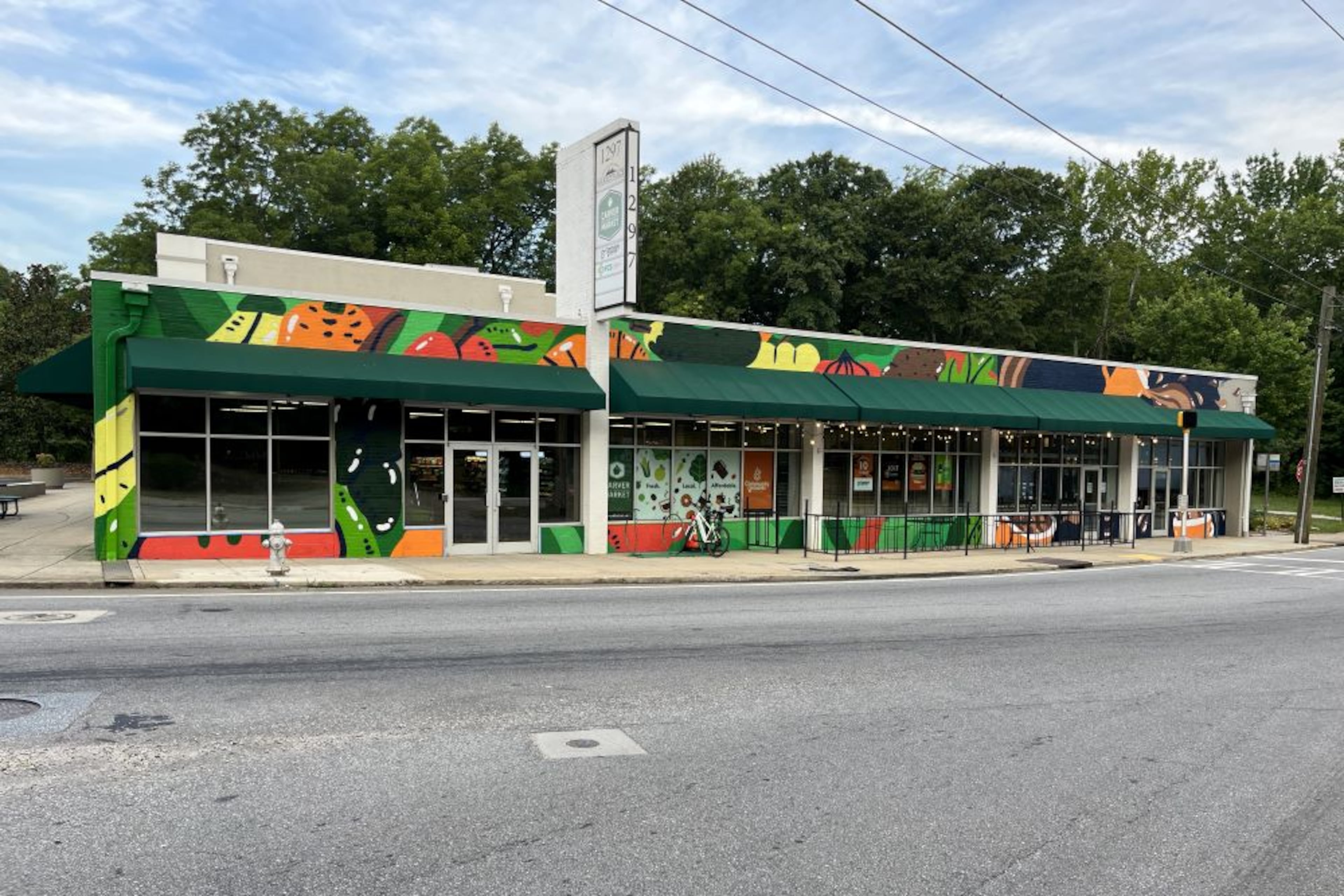 Muralist George F. Baker III created the facade outside of Carver Neighborhood Market and Community Grounds Coffee Shop. (Courtesy of Focused Community Strategies)
