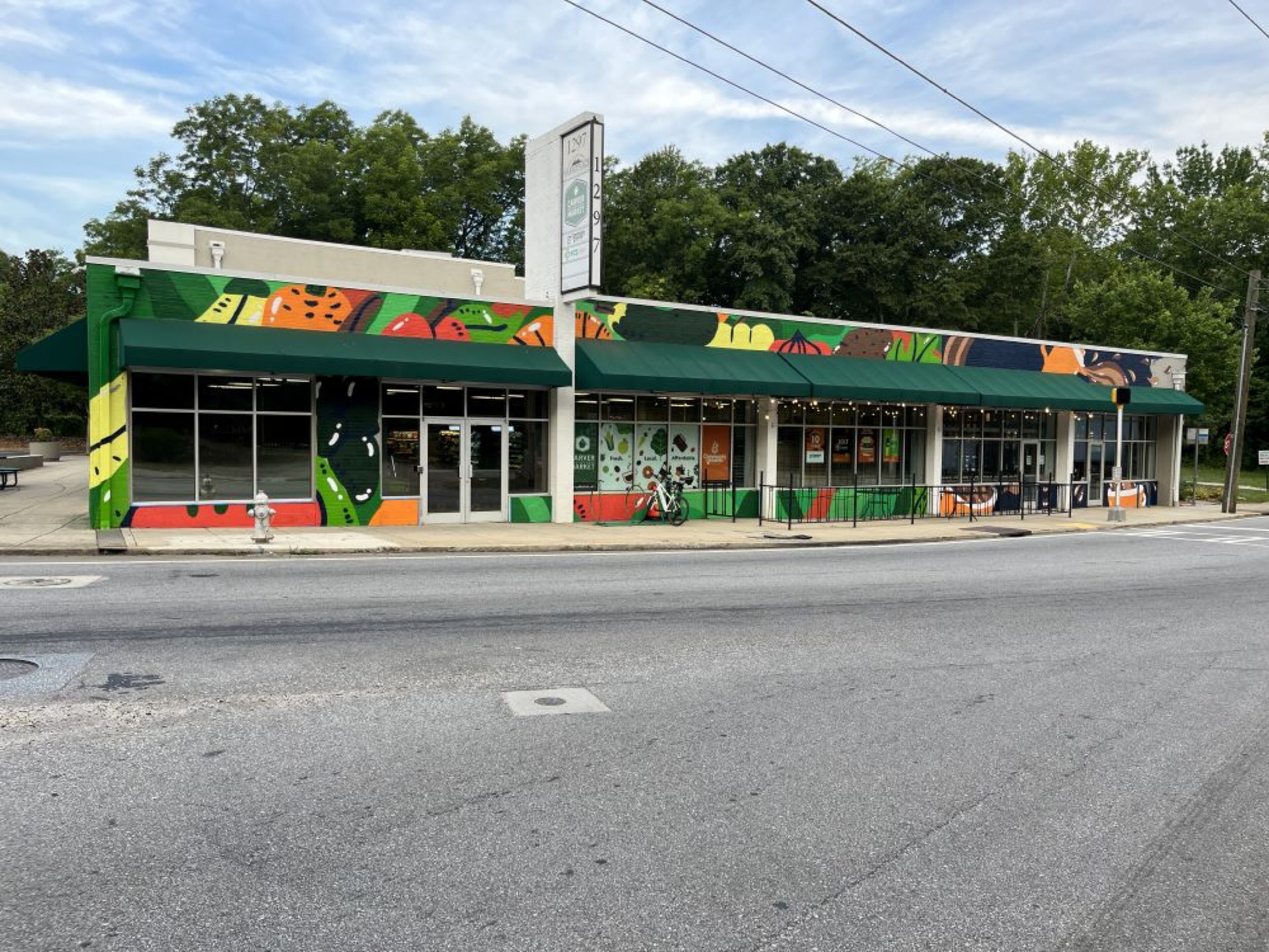 Muralist George F. Baker III created the facade outside of Carver Neighborhood Market and Community Grounds Coffee Shop. (Courtesy of Focused Community Strategies)