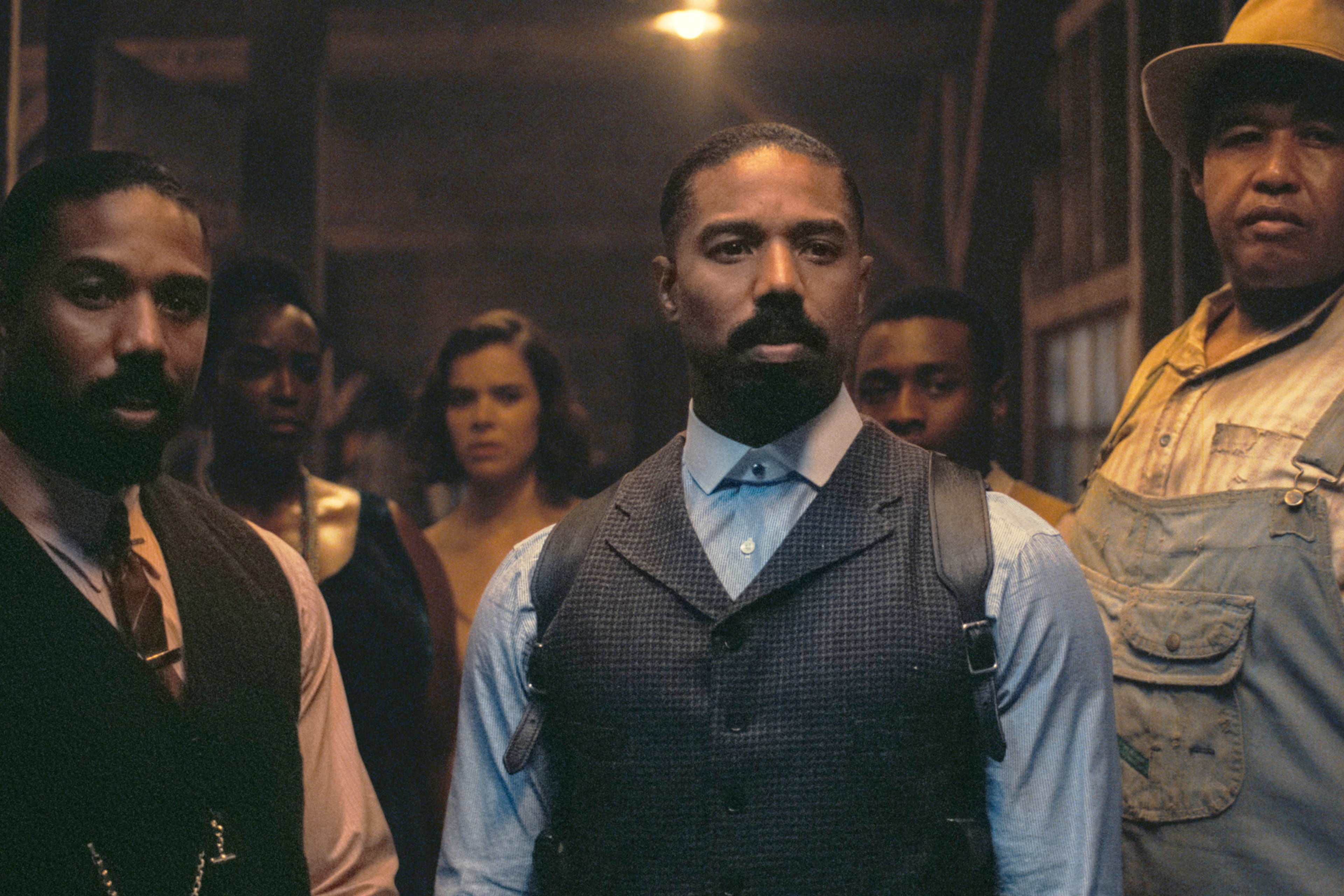 This image released by Warner Bros Pictures shows Michael B. Jordan, foreground from left, Michael B. Jordan and Omar Benson Miller in a scene from "Sinners." (Warner Bros. Pictures via AP)