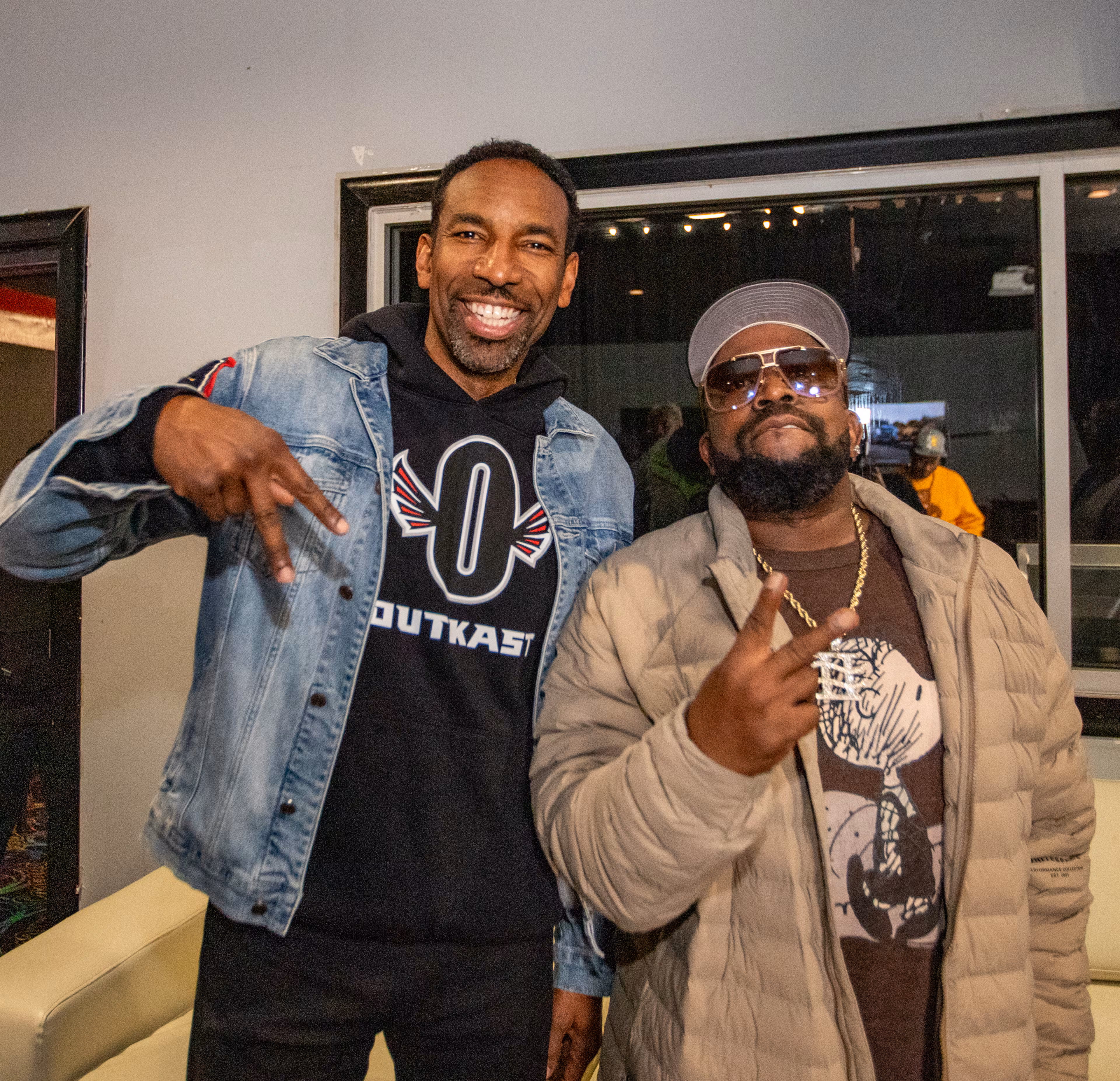 Mayor Andre Dickens and Outkast’s Big Boi catch up in the green room at Cascade Skate during a party celebrating the 25th anniversary of Outkast's fourth album, "Stankonia," on Thursday. (Jenni Girtman for the AJC)