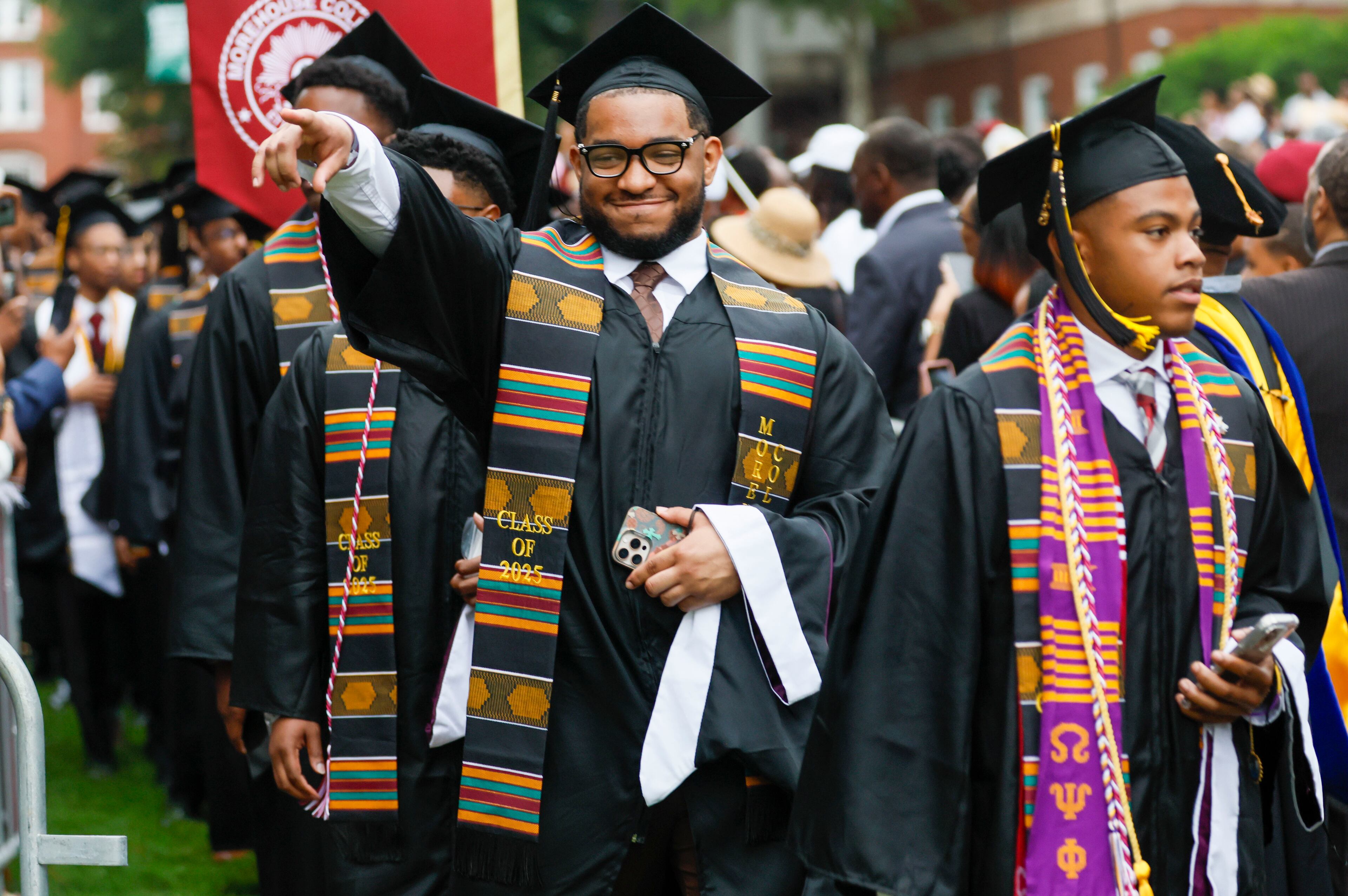 A graduate reacts to family members as he enters the ceremony during Morehouse College's 141st Commencement Ceremony on Sunday, May 18, 2025. The school has seen a spike in interest in recent years, receiving a record-high number of applications.  
(Miguel Martinez/ AJC)