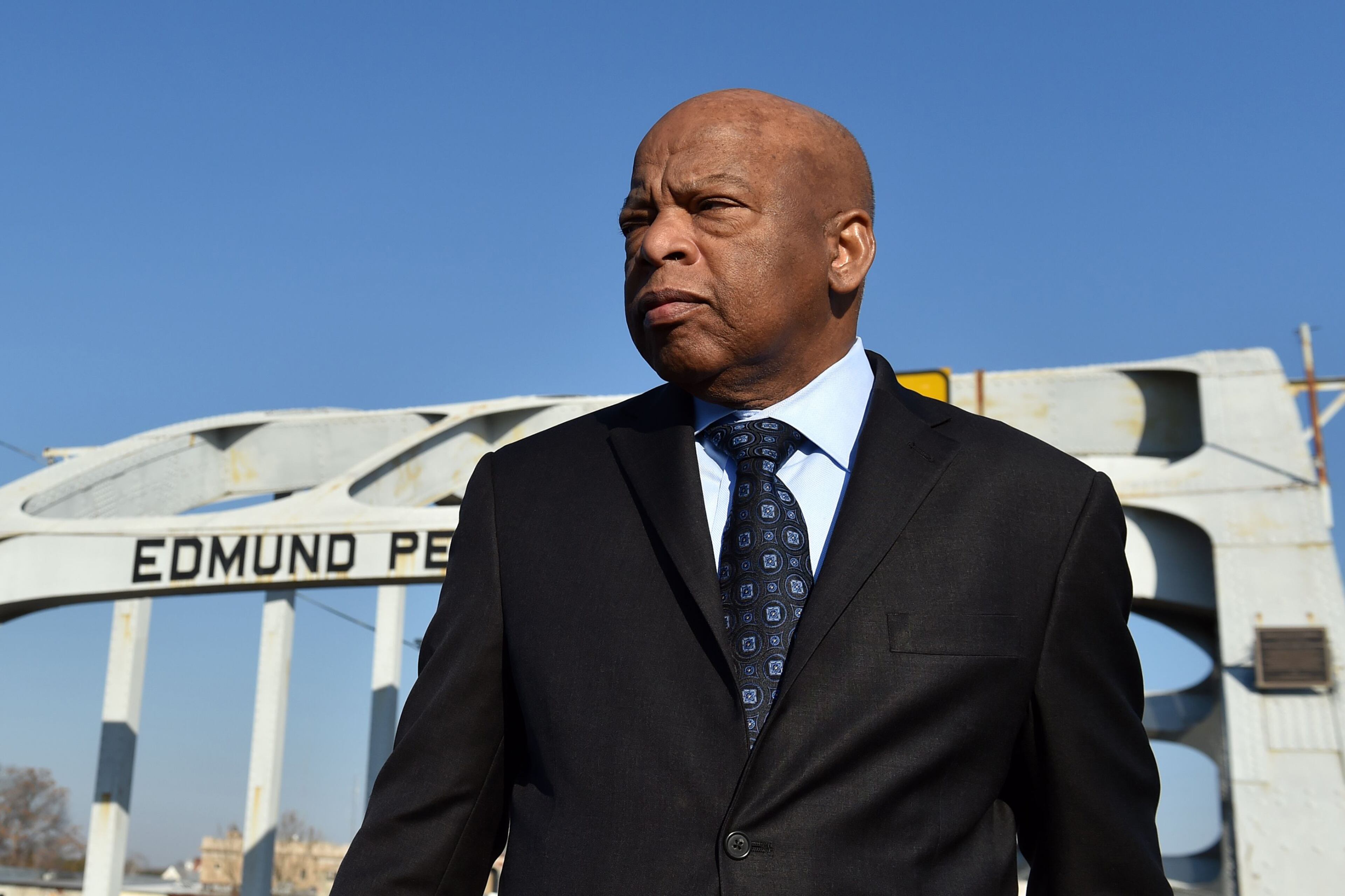 Rep. John Lewis stands on the Edmund Pettus Bridge in February 2015. On March 7, 1965, he helped lead 600 civil rights activists across the bridge in a march for voting rights. The former congressman from Georgia died of cancer in 2020. (AJC 2015)