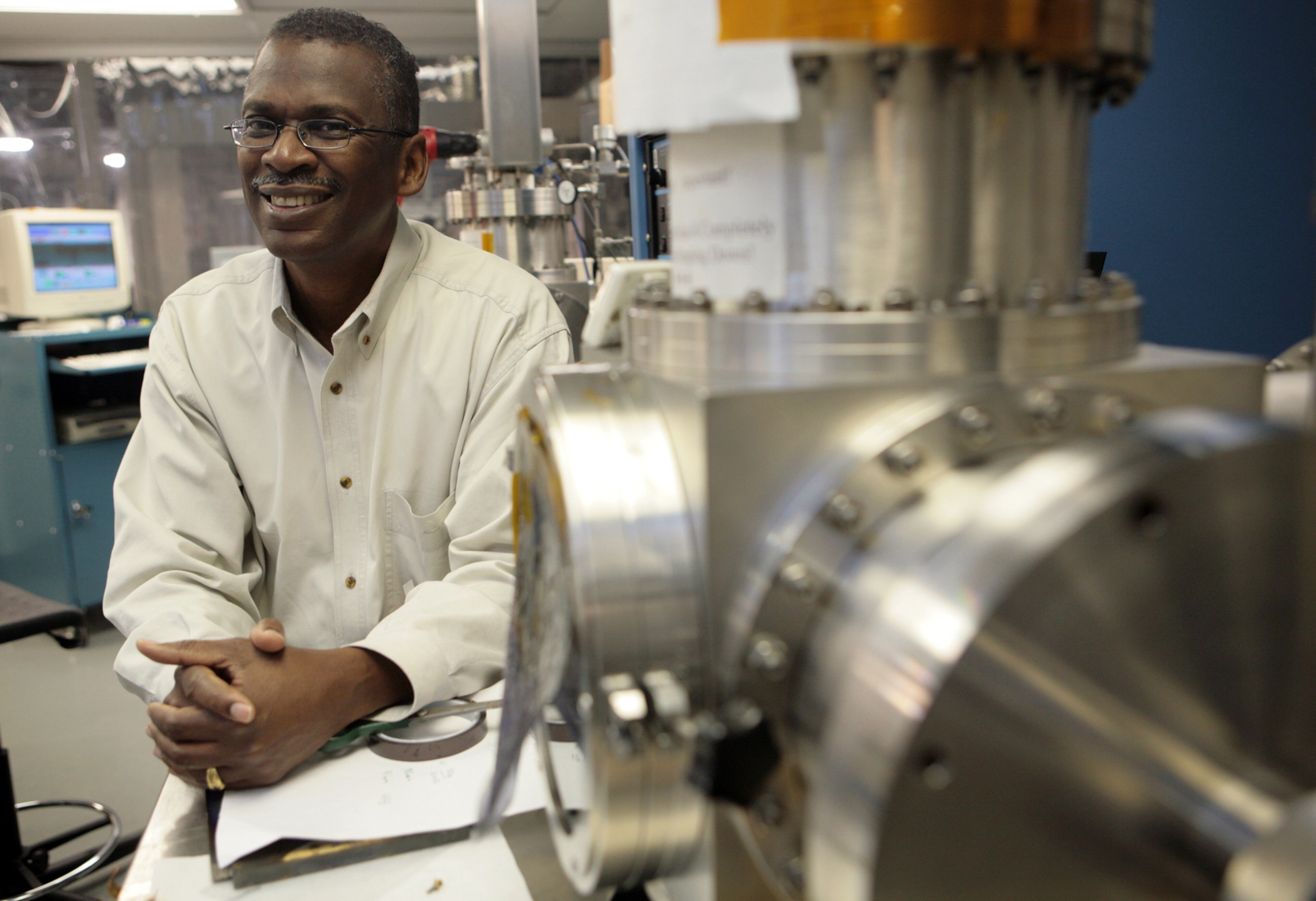 Atlanta inventor Lonnie Johnson, the creator of the Super Soaker, stands next to a sputtering system machine in his labs in downtown Atlanta on Oct. 20, 2008. (AJC File Photo)