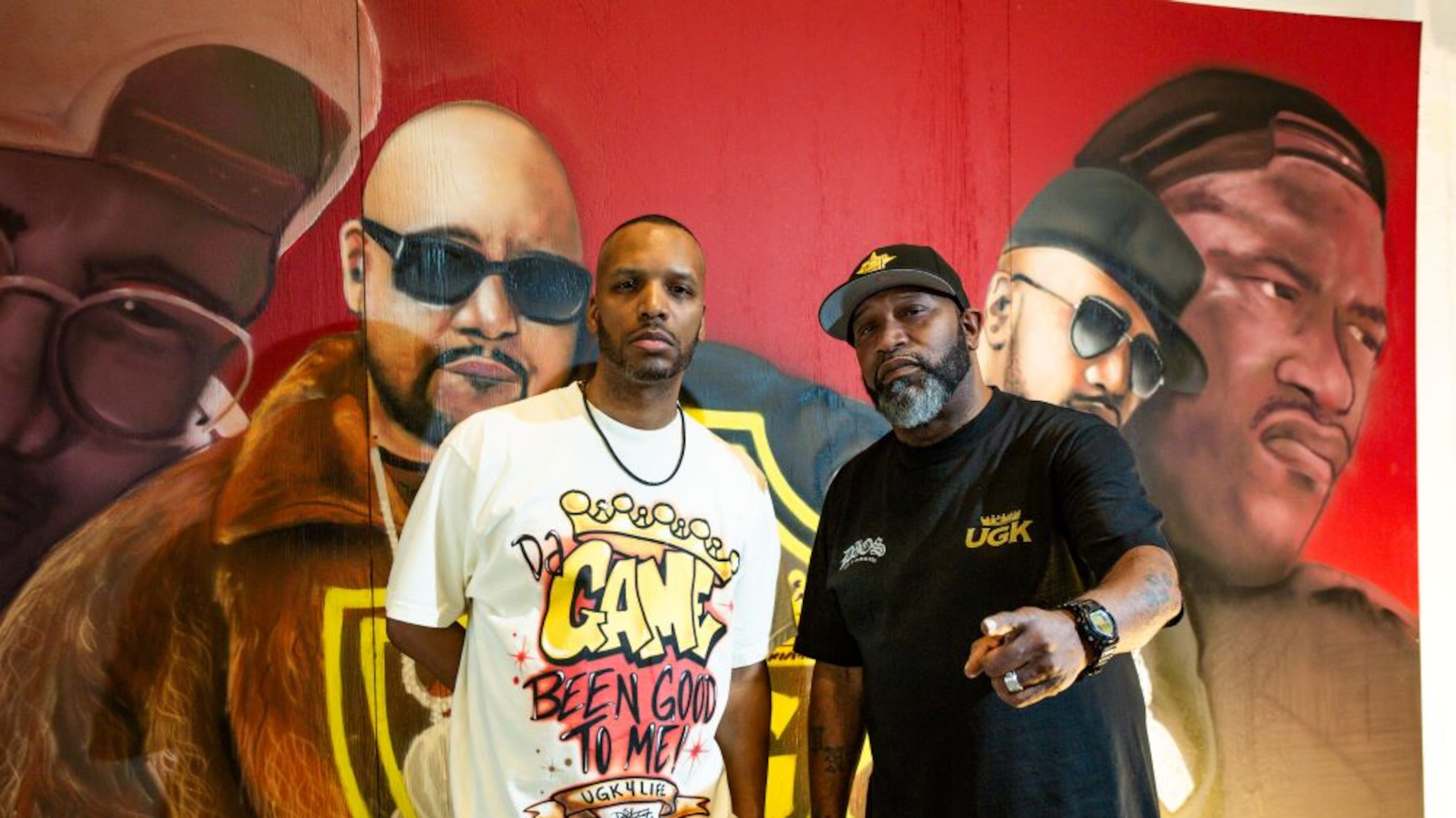 Cory Mo (left) and Bun B stand in front of a mural of the group UGK. (Pimp C is wearing sunglasses and a young Bun is on the right). (Courtesy of Marco Torres)