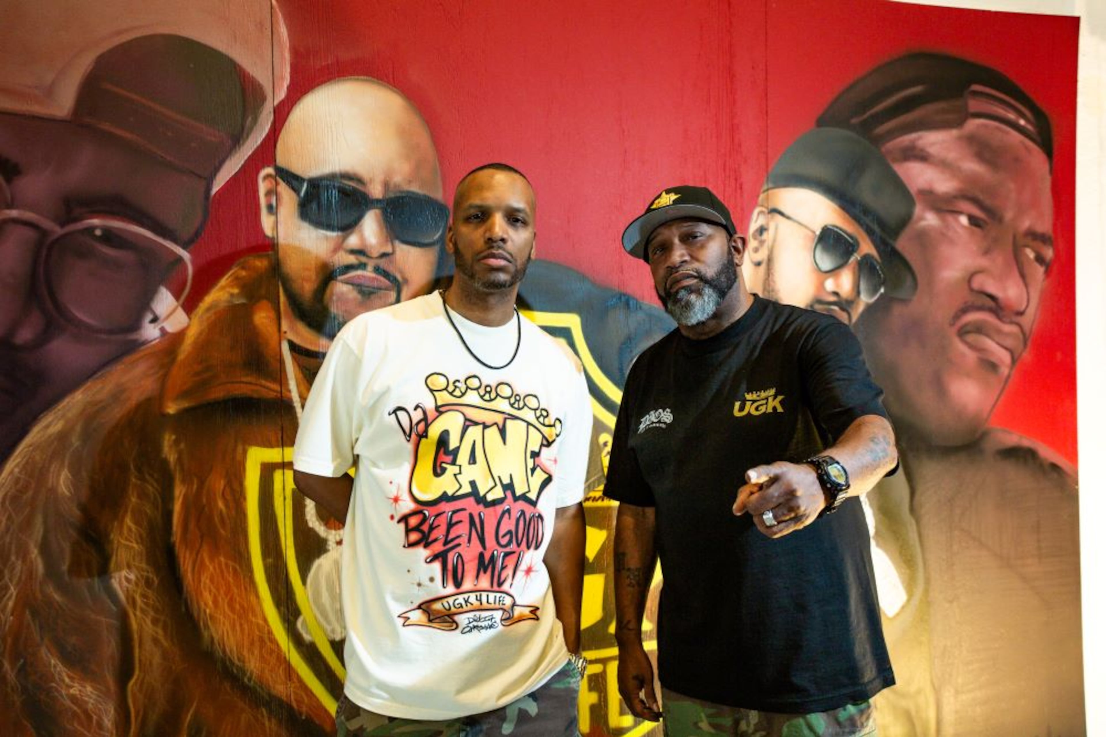 Cory Mo (left) and Bun B stand in front of a mural of the group UGK. (Pimp C is wearing sunglasses and a young Bun is on the right). (Courtesy of Marco Torres)