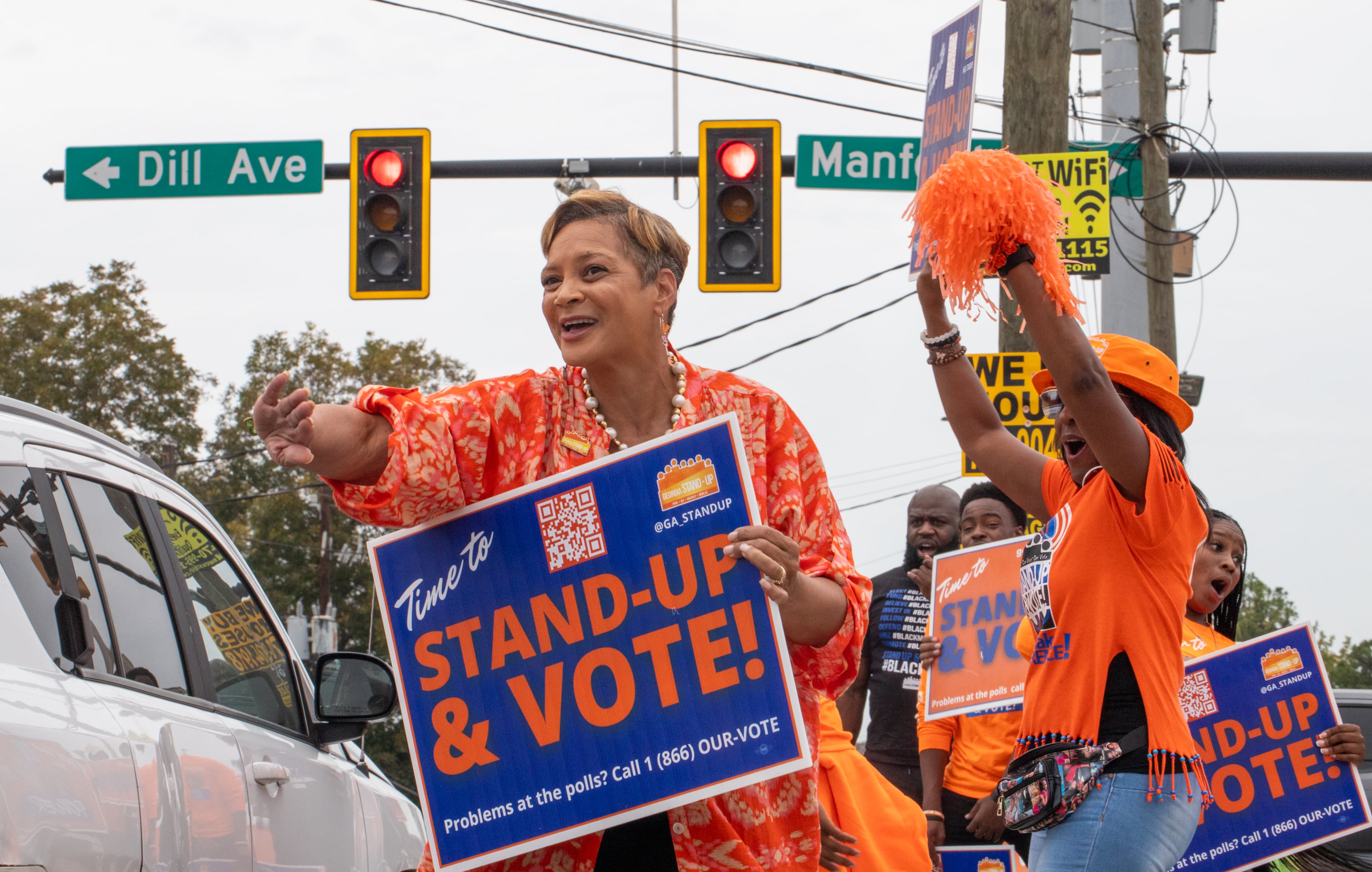 Several nonprofit, nonpartisan groups, including Deborah Scott, CEO of Georgia Stand Up, dance, cheer and provide free food, information and swag to encourage people to vote Friday, Nov. 1, 2024. (Jenni Girtman for the AJC)